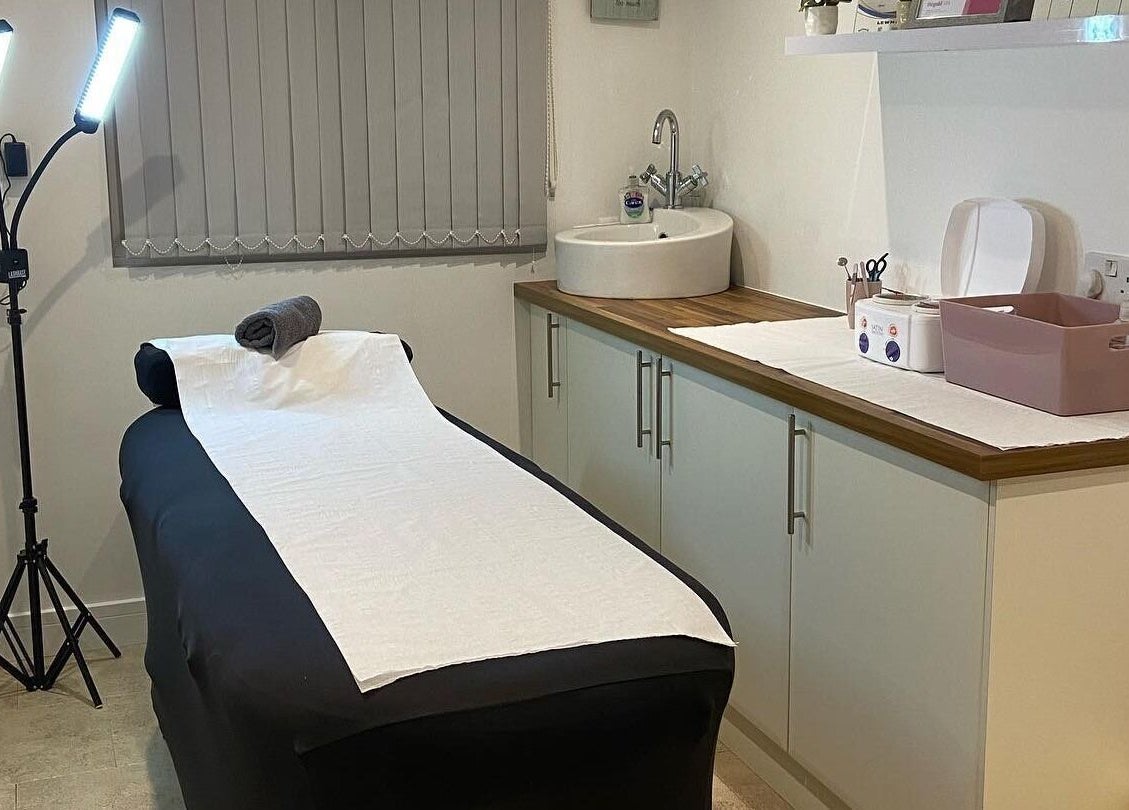 Cozy treatment room at Debeaut by Della in Havant, England, GB, featuring a massage table and calming decor.