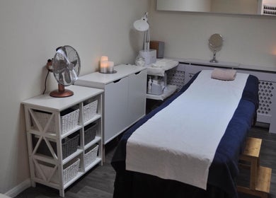 Calm treatment room at Bare Beauty by Sarah, Minehead, England, GB, with table and ambient lighting.