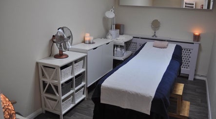 Calm treatment room at Bare Beauty by Sarah, Minehead, England, GB, with table and ambient lighting.