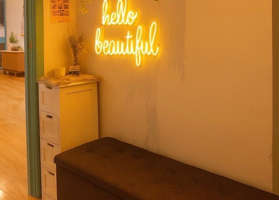 Warm inviting interior of Sienna Beauty Bar, Melbourne, Victoria, AU featuring 'hello beautiful' neon sign.