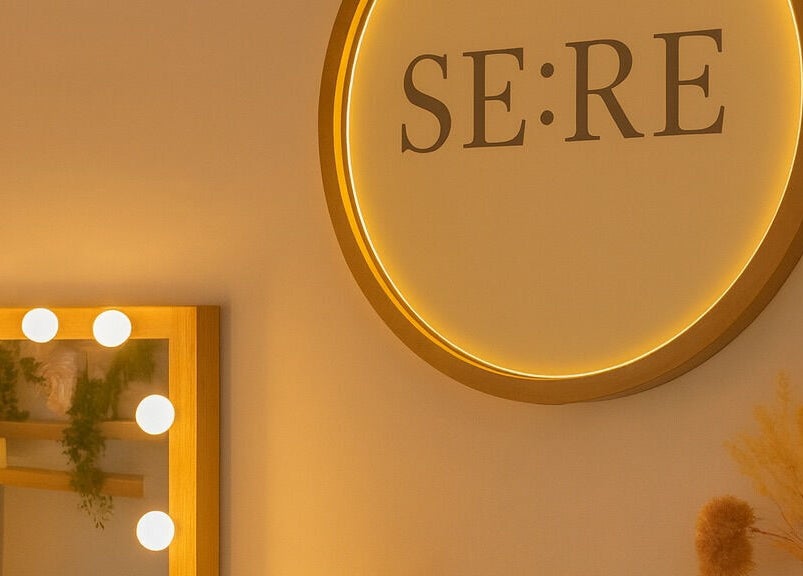 Warm-lit vanity and SE:RE sign at Sienna Beauty Bar, Melbourne, Victoria, AU.