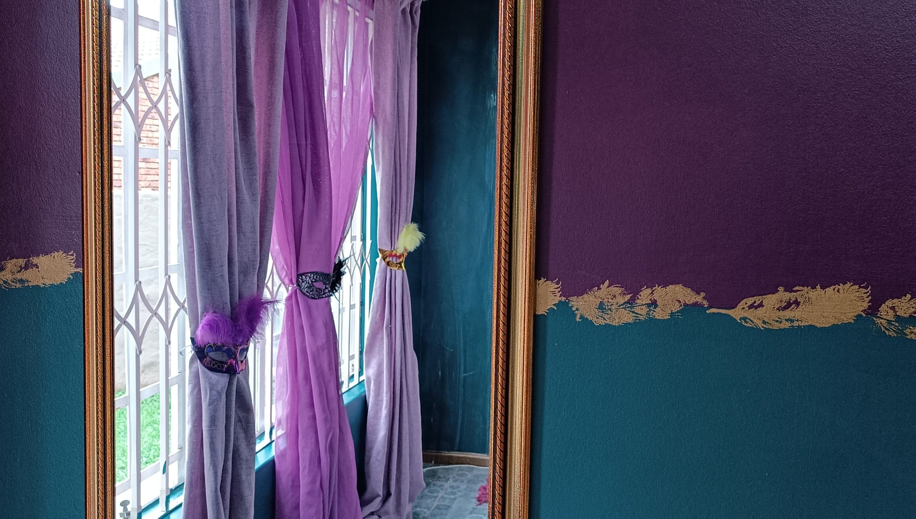 Purple and gold decor at D-vinely Unique Artistry, Pretoria, Gauteng, ZA brightens the room's window view.