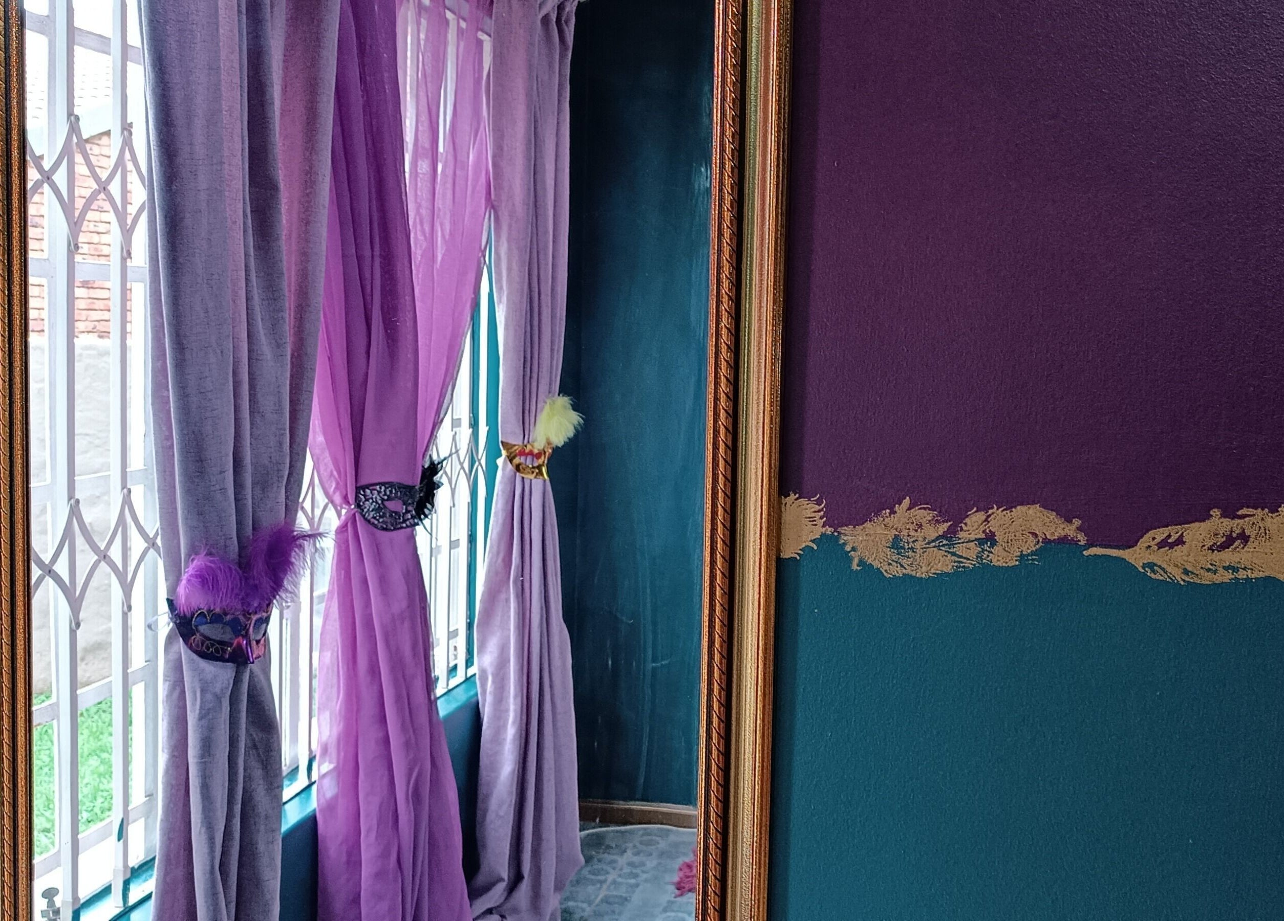 Purple and gold decor at D-vinely Unique Artistry, Pretoria, Gauteng, ZA brightens the room's window view.