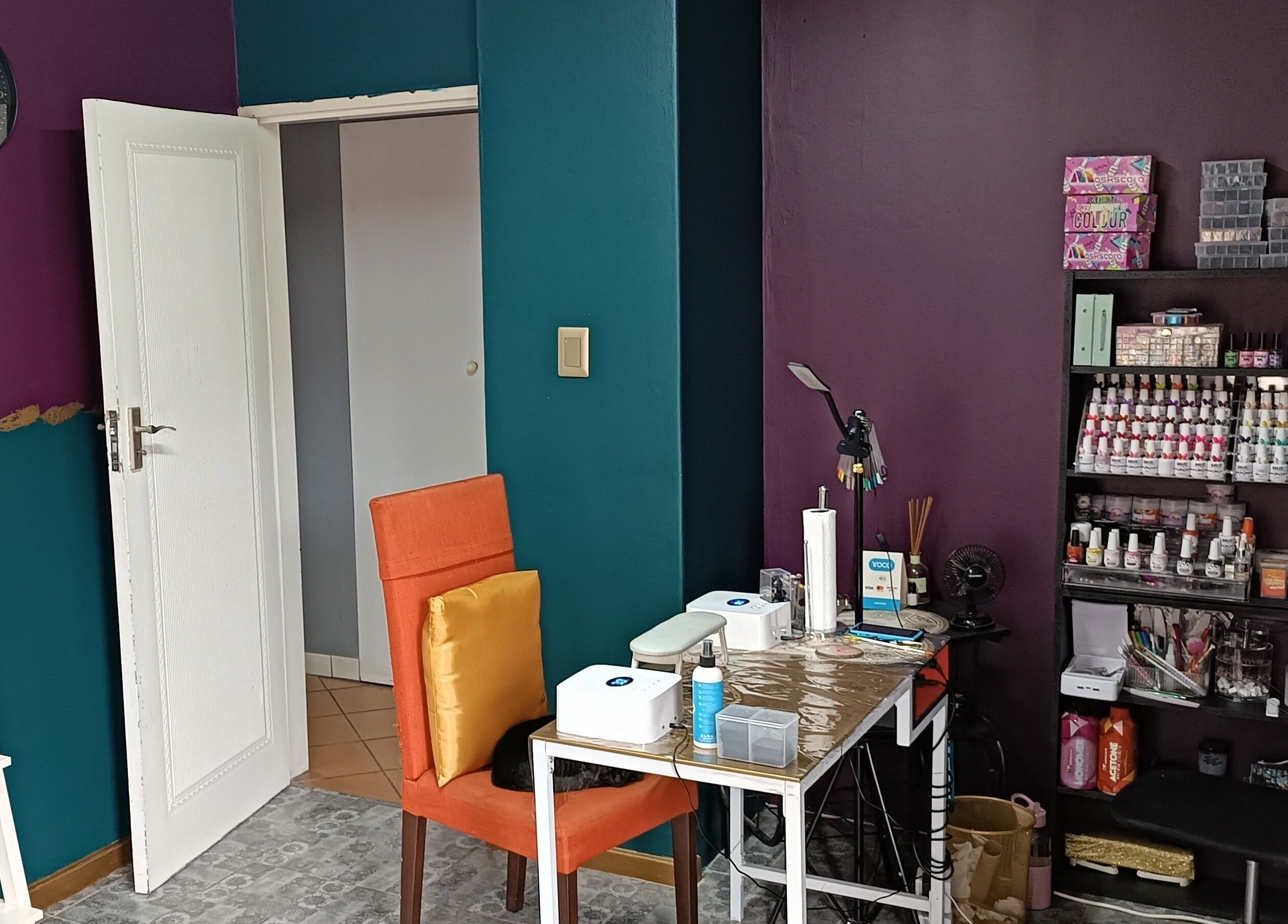 Chic nail art station at D-vinely Unique Artistry in Pretoria, Gauteng, ZA with colorful decor.