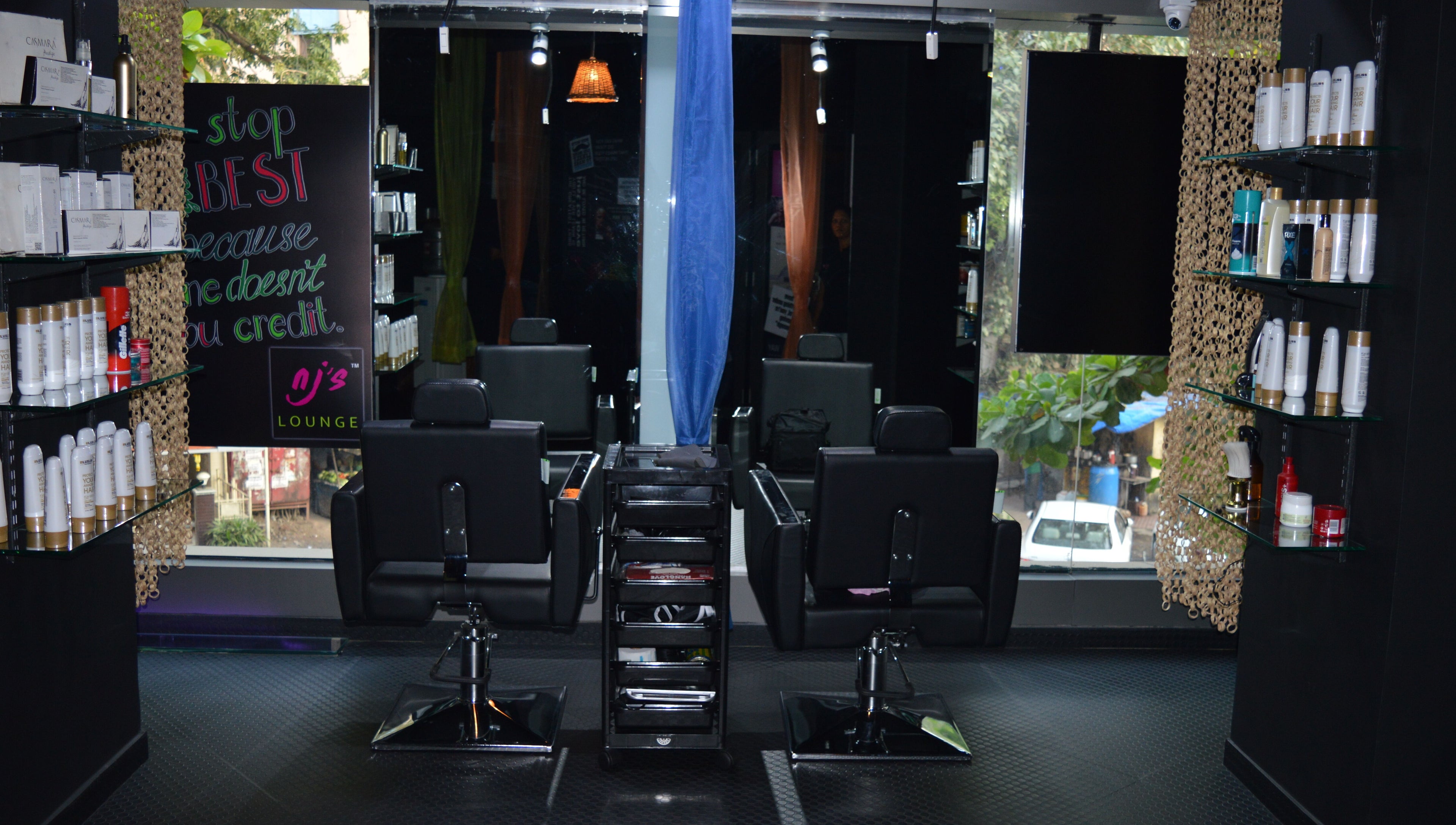 Interior of Nj's Lounge Talaopali Branch - Thane featuring stylish salon chairs. Located in Thane, Maharashtra, IN.