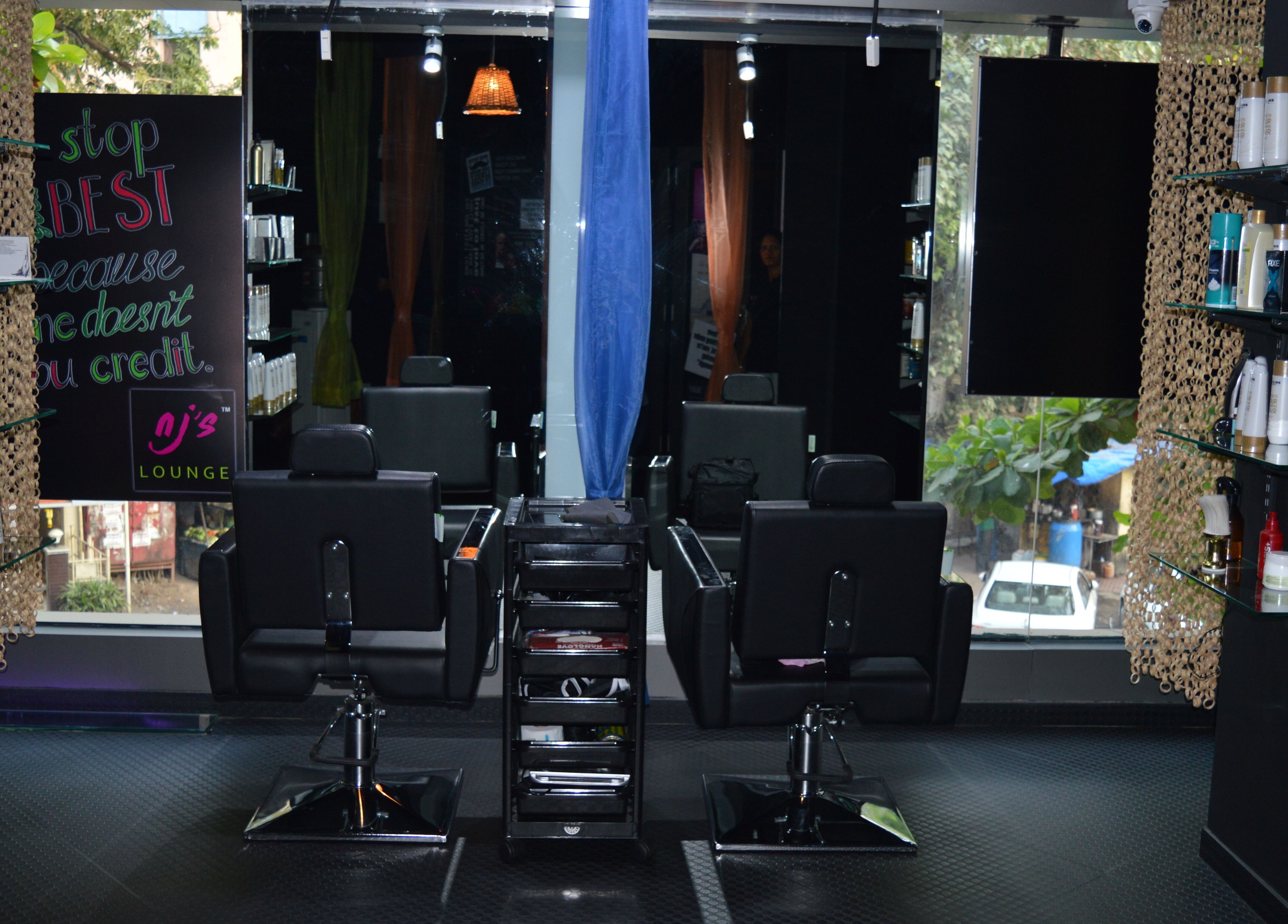 Interior of Nj's Lounge Talaopali Branch - Thane featuring stylish salon chairs. Located in Thane, Maharashtra, IN.