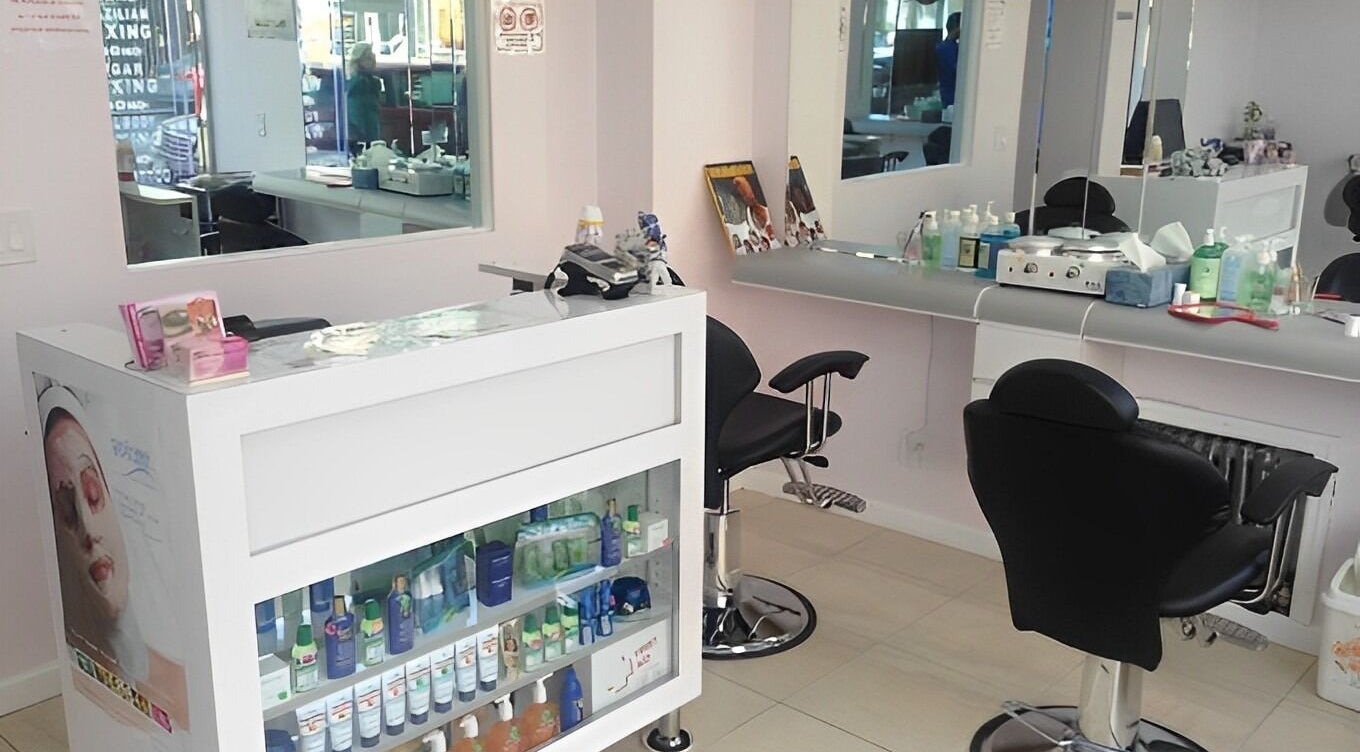Modern interior of Unique Beauty Salon in New York, New York, US, showcasing styling chairs and products.
