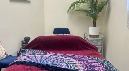 Relaxing therapy room at Te Whare O Kawakawa Spa, Fairfield, Hamilton, NZ with lush decor.