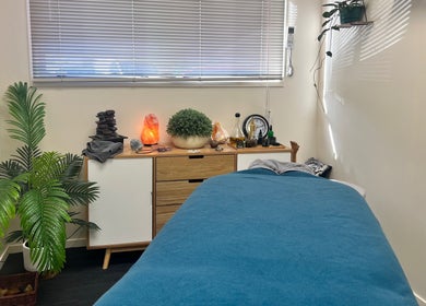 Relaxing spa room at Te Whare O Kawakawa Spa, Fairfield, Hamilton, NZ. Cozy ambiance with lush plants.