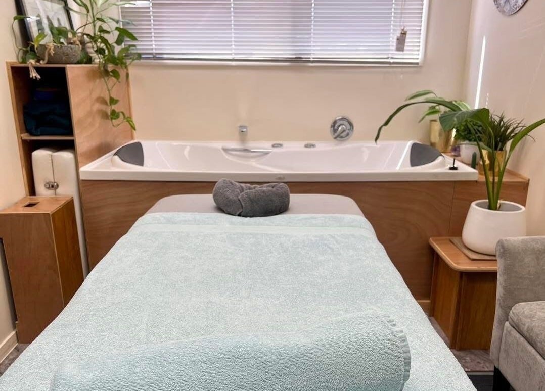 Cozy massage room at Te Whare O Kawakawa Spa in Fairfield, Hamilton, NZ with inviting decor.