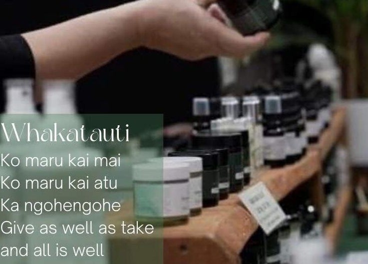 A hand selects a skincare product at Te Whare O Kawakawa Spa, Fairfield, Hamilton, NZ.