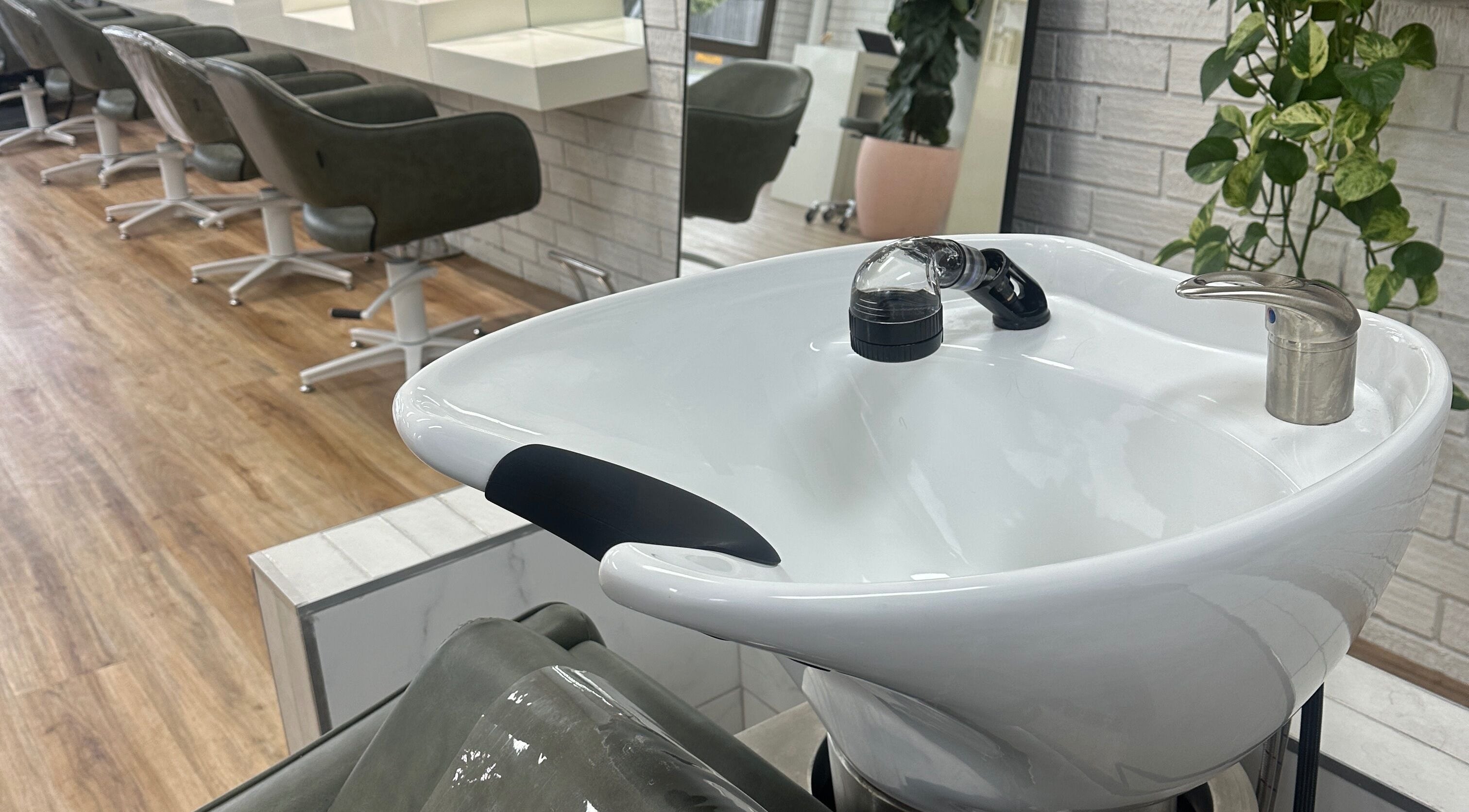 Modern salon interior at Two Blondes, Melbourne, Victoria, AU, featuring chic styling chairs and wash basin.