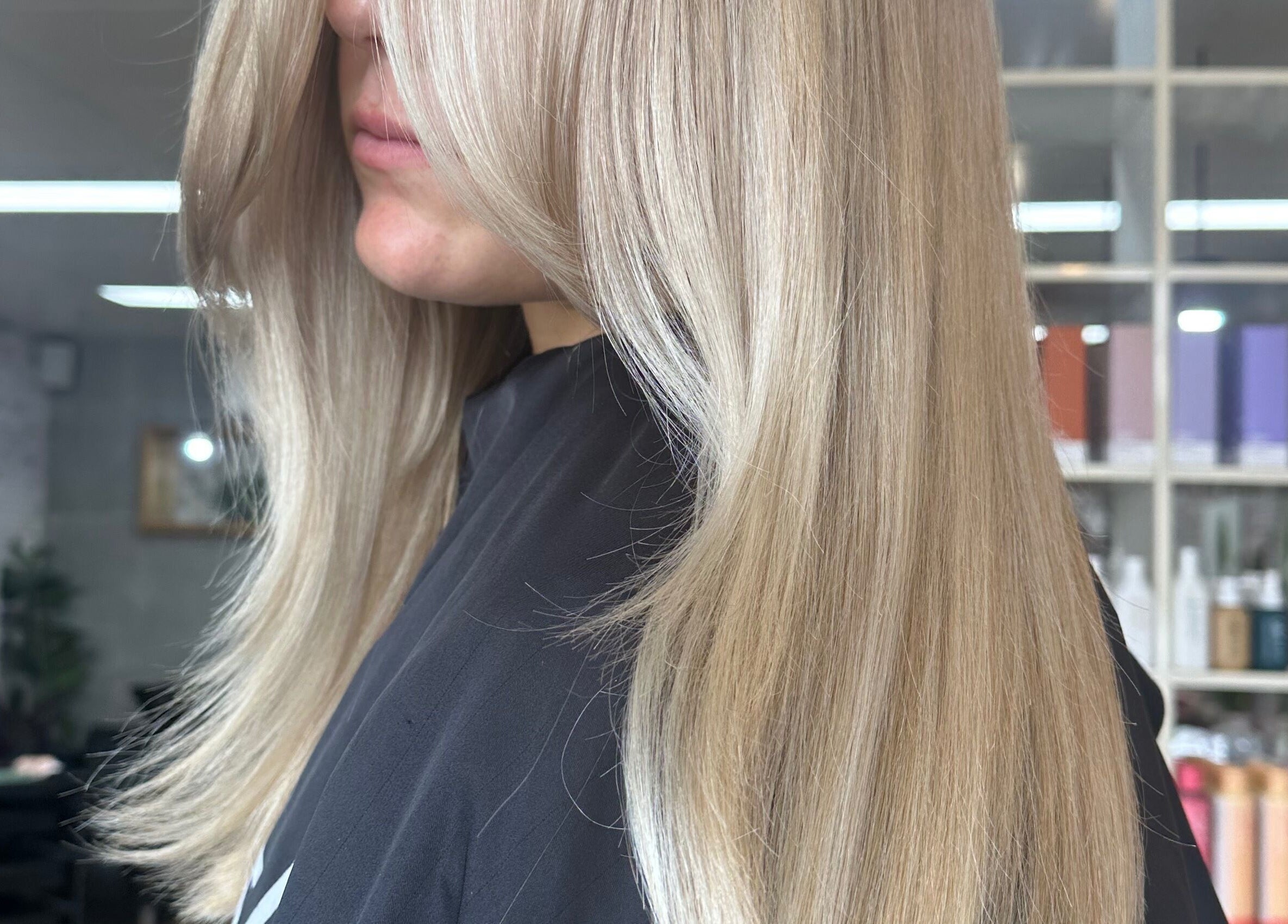 Sleek blond hair styled at Two Blondes, Melbourne, Victoria, AU salon for a radiant finish.