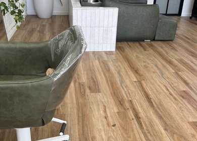 Modern salon chair at Two Blondes, Melbourne, Victoria, AU, showcasing chic wooden flooring and elegant decor.