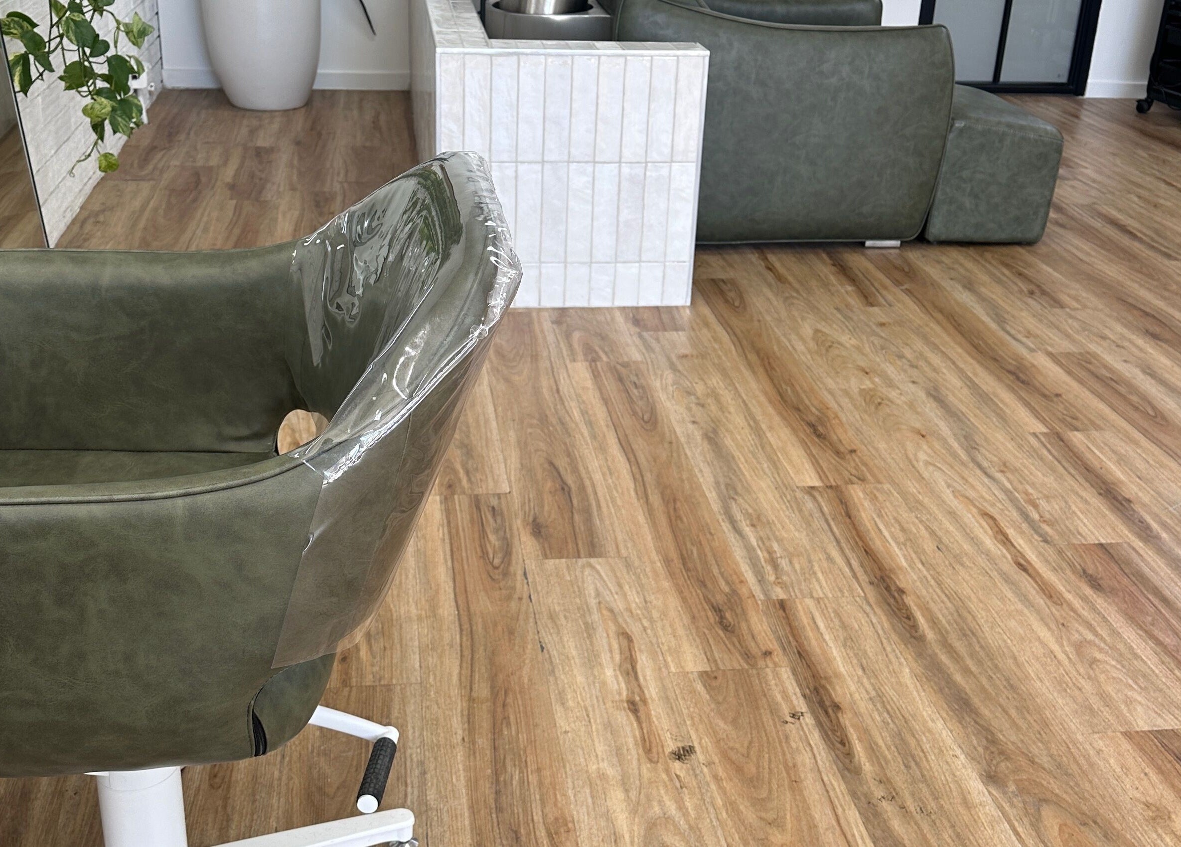 Modern salon chair at Two Blondes, Melbourne, Victoria, AU, showcasing chic wooden flooring and elegant decor.