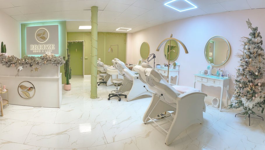 Chic interior of Breeze Brow and Lash in Glasgow, Scotland, GB with stylish chairs and festive decor.