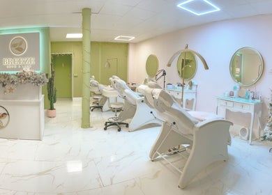 Chic interior of Breeze Brow and Lash in Glasgow, Scotland, GB with stylish chairs and festive decor.