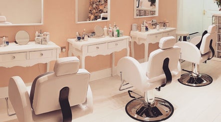 Elegant makeup stations at Breeze Brow and Lash in Glasgow, Scotland, GB, with plush white chairs and mirrors.