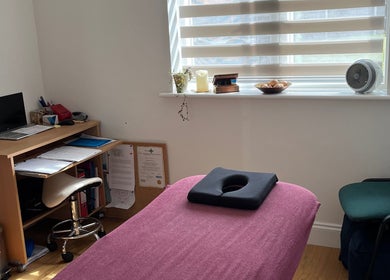 JH Sport Manual Therapy cozy room in Norwich, England, GB with a treatment table, desk, and natural light.