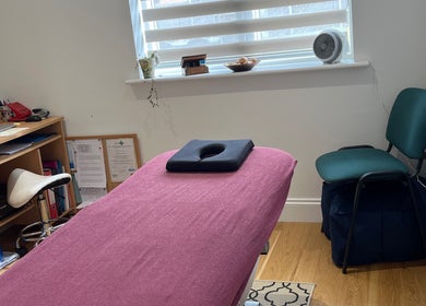 Comfortable therapy room at JH Sport Manual Therapy, Norwich, England, GB with massage table and desk.