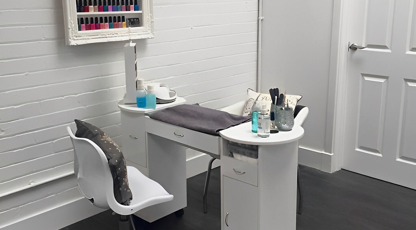 Nail station at Bee Beauty, Bathgate, Scotland, GB. Elegant setup with polishes and tools in a serene setting.