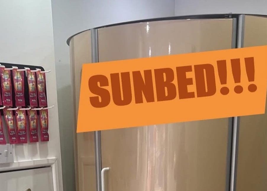 Sunbed area at All Dolled Up - Leeds, Kippax, England, GB with tanning lotions displayed.