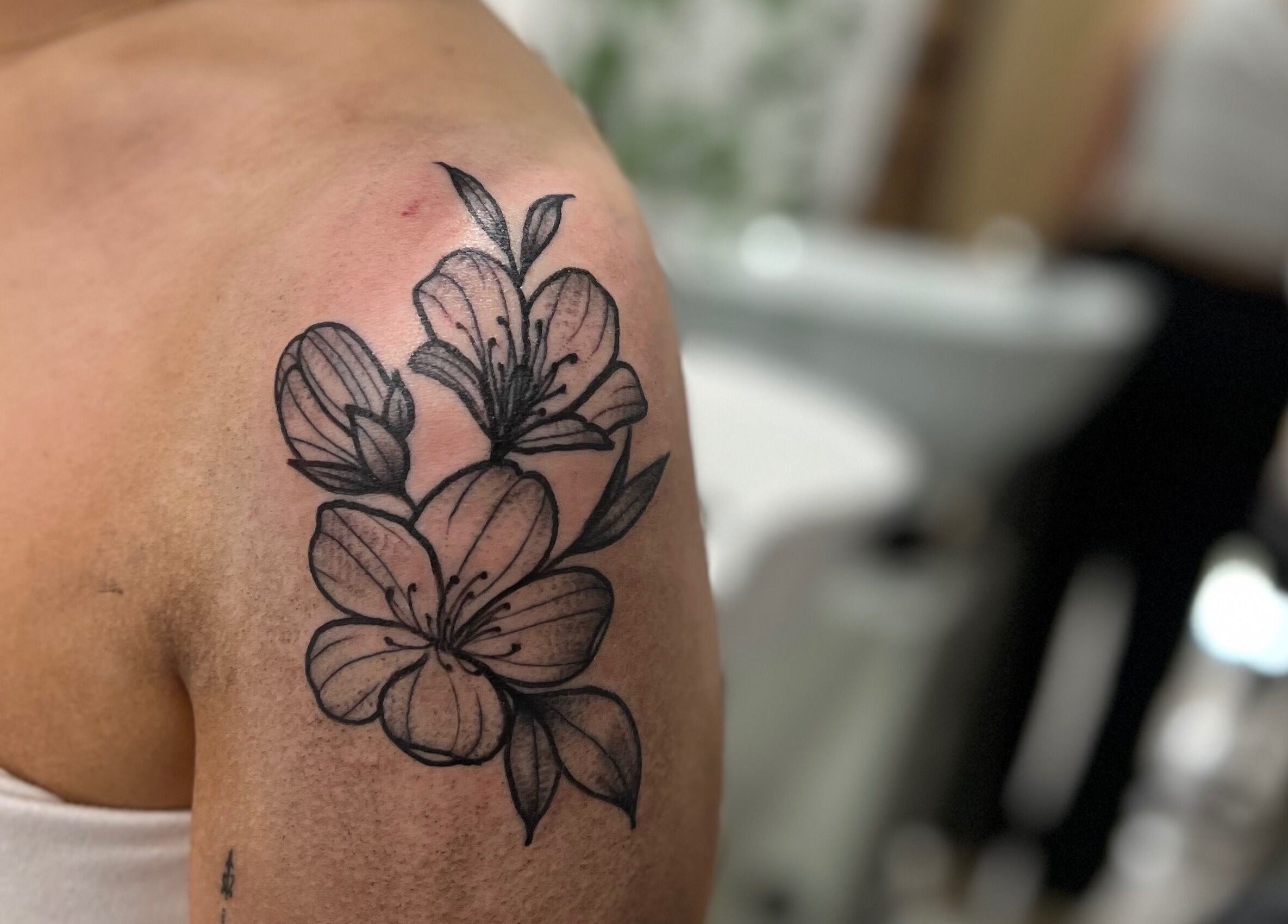 Floral tattoo on arm at All Dolled Up - Leeds, Kippax, England, GB. Elegant artistry captured.