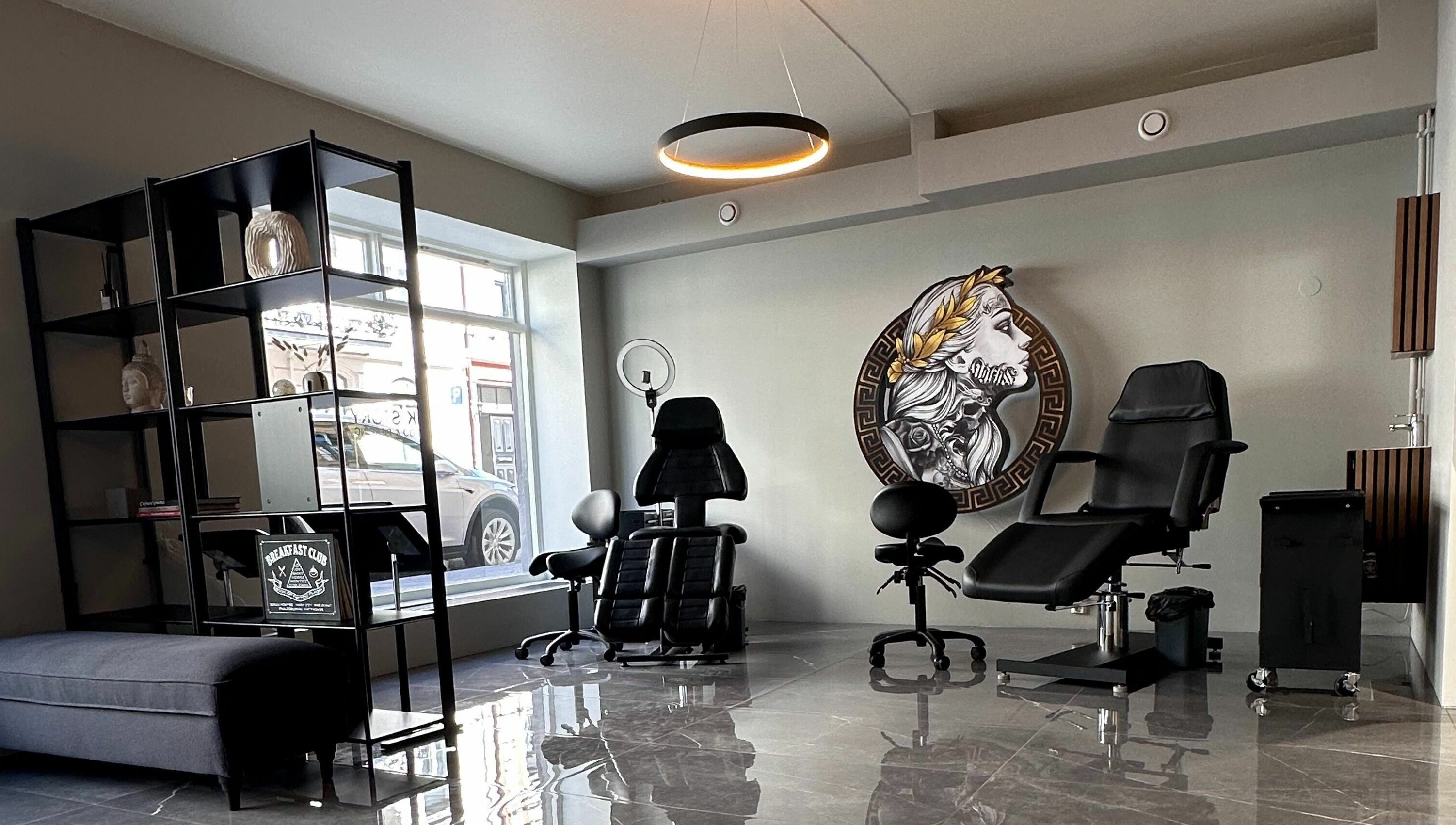 Modern tattoo studio interior at Oslo, Oslo, NO with elegant chairs and wall art.