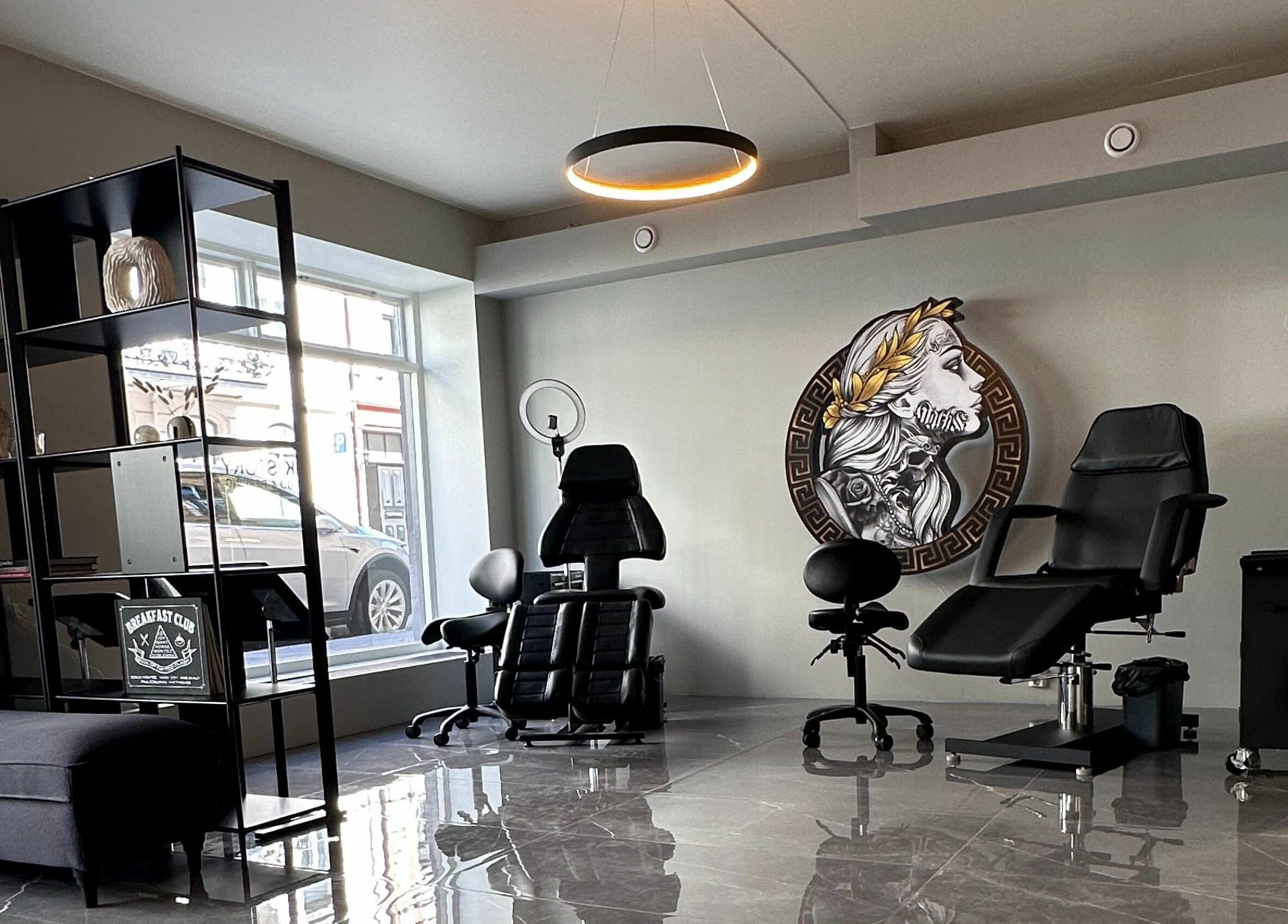 Modern tattoo studio interior at Oslo, Oslo, NO with elegant chairs and wall art.