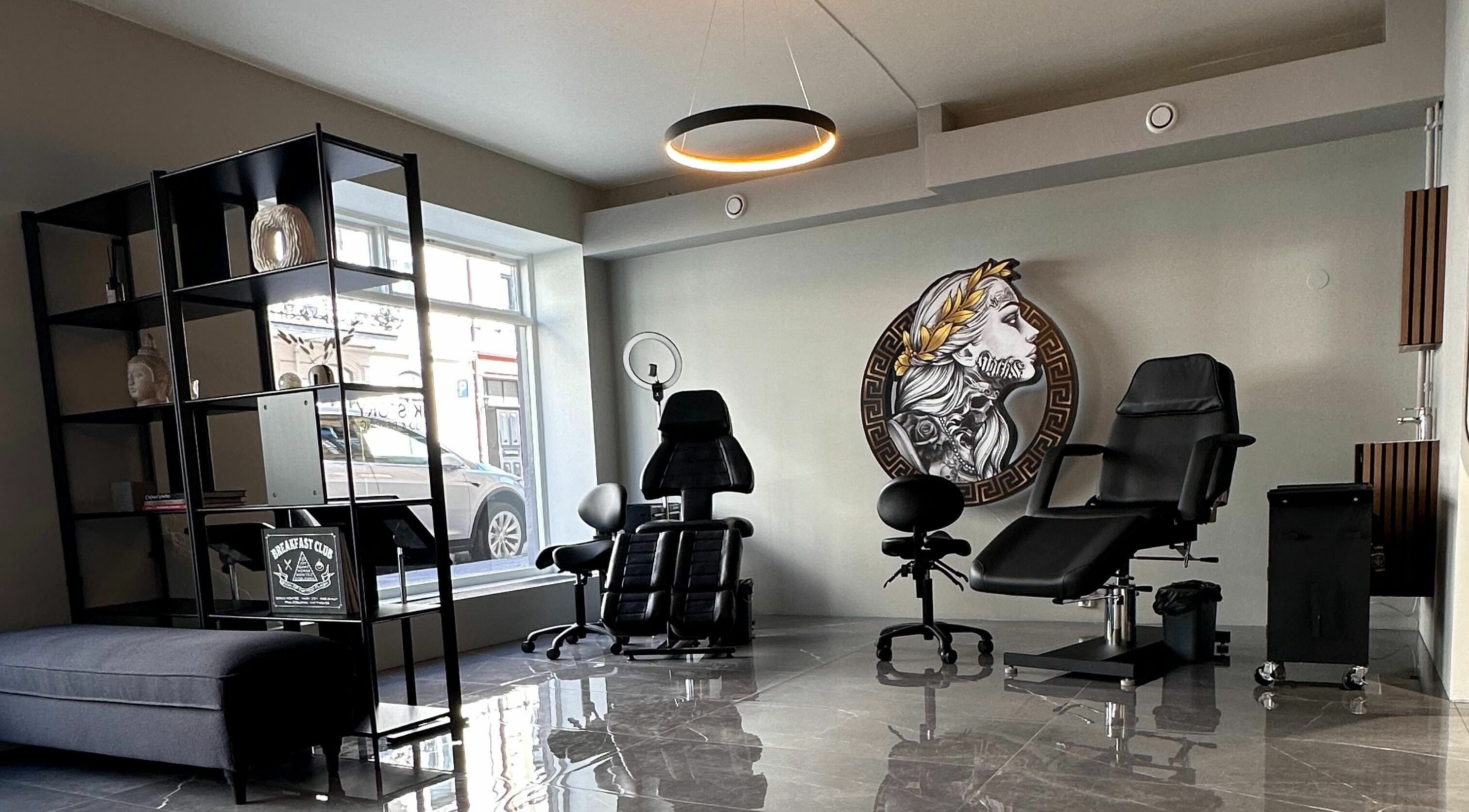 Modern tattoo studio interior at Oslo, Oslo, NO with elegant chairs and wall art.