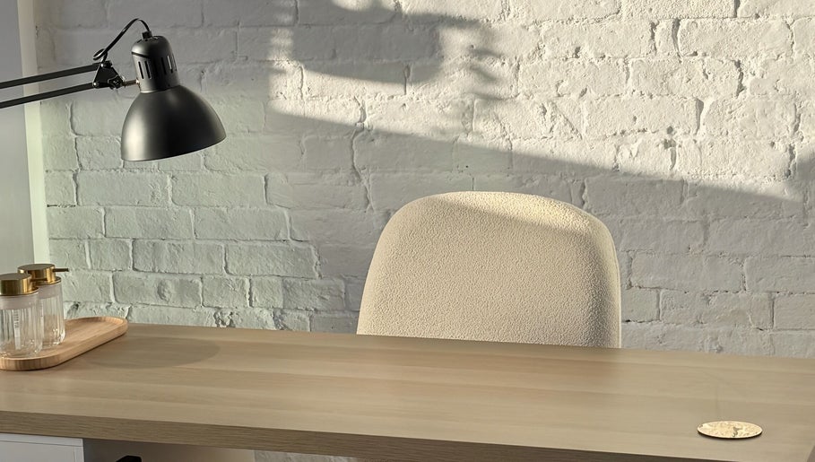 Minimalist workspace at Amethys at The Granary, Polesworth, England, featuring a desk and a modern lamp.