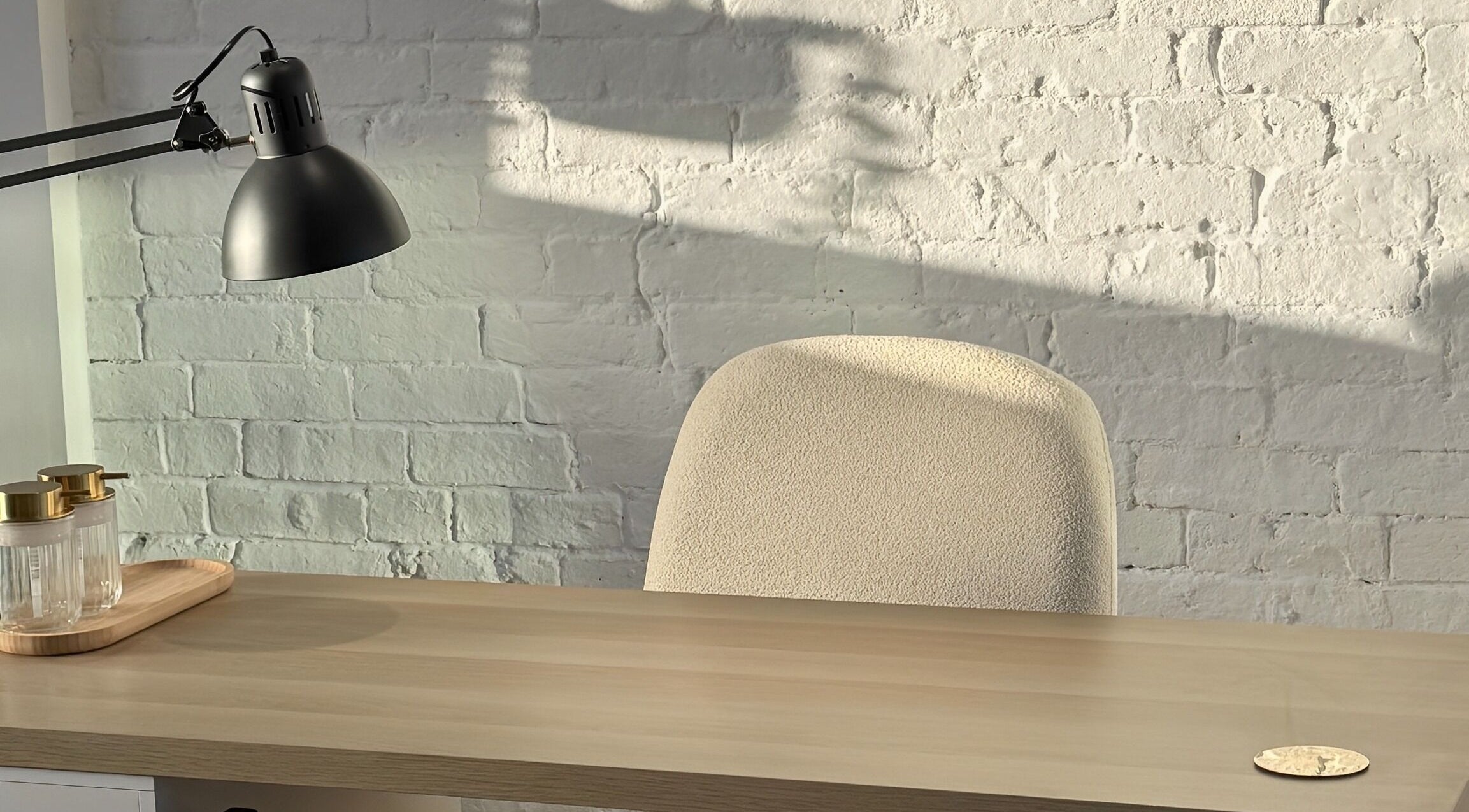 Minimalist workspace at Amethys at The Granary, Polesworth, England, featuring a desk and a modern lamp.