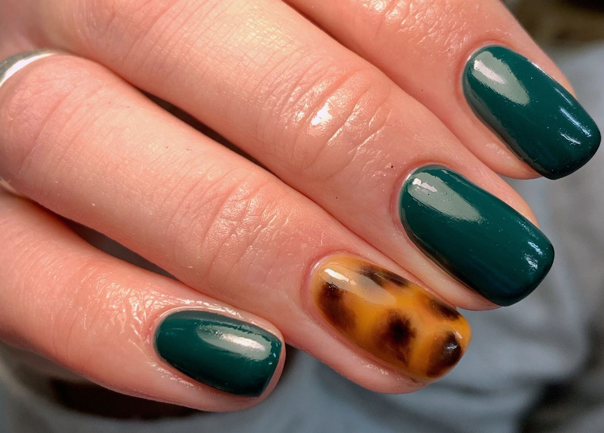 Green and tortoiseshell nail art at Amethys at The Granary, Polesworth, England, GB; stylish and elegant design.
