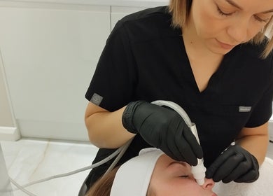 Facial treatment at Amani Beauty Clinic in Pool, England, GB. Aesthetician using advanced equipment.