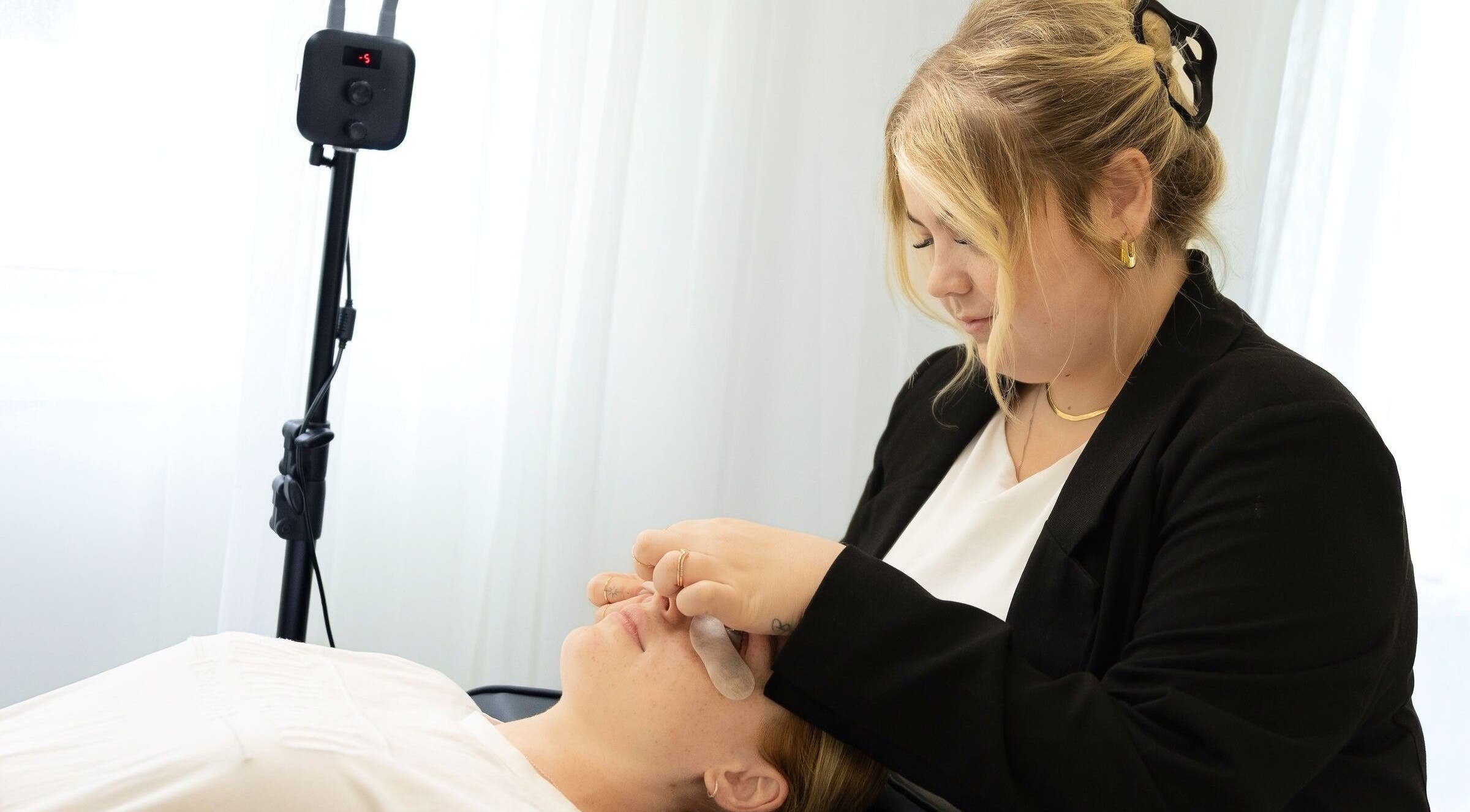 Professional performing lash service at Iconic Lash & Brow, Woongarrah, New South Wales, AU.