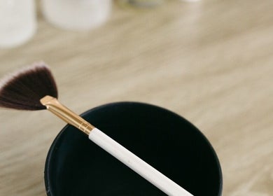 Fan makeup brush at Brittney Finch Esthetics in Ottawa, Ontario, CA on a wooden table.
