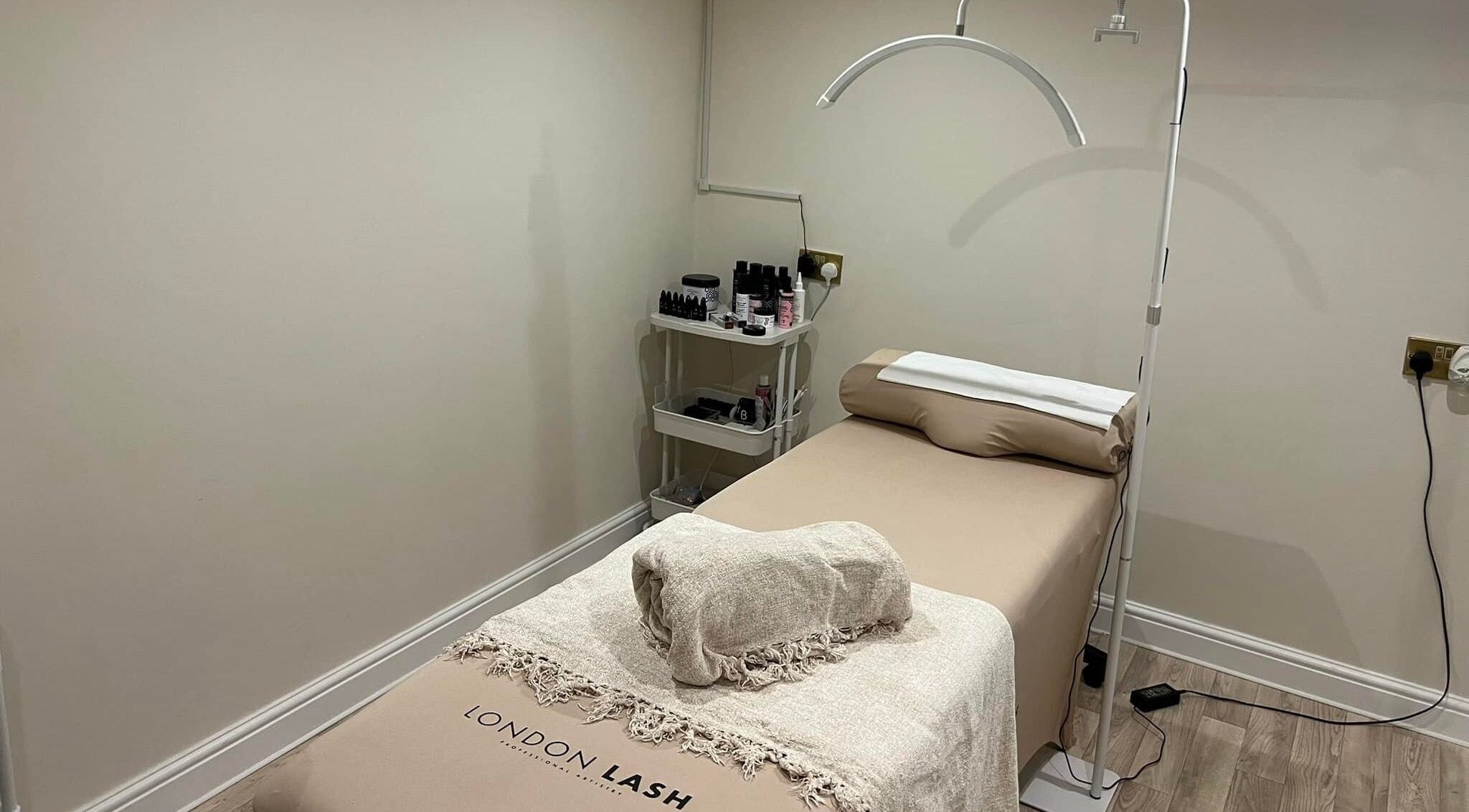 Tranquil spa room at Be Beau Boutique, featuring a massage bed and soothing decor in Paignton, England, GB.