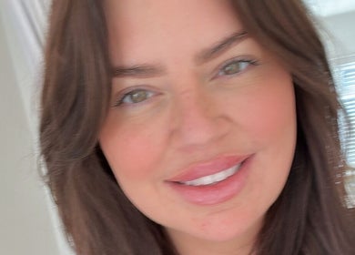 Smiling woman at Faceology - Hythe in Lympne, England, GB, exemplifying relaxed wellness and beauty ambiance.