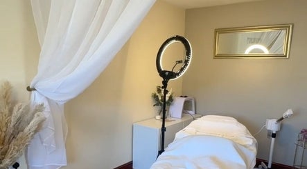 Relaxing treatment room at Faceology - Hythe, Hythe, Lympne, England, GB with white linens and soft lighting.