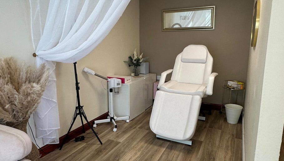 Elegant treatment room at Faceology - Hythe, Hythe, Lympne, England, GB with plush chair and soft lighting.