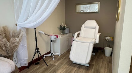 Elegant treatment room at Faceology - Hythe, Hythe, Lympne, England, GB with plush chair and soft lighting.