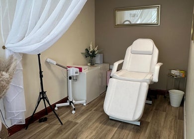 Faceology treatment room in Lympne, Hythe, England, GB with a white spa chair and soft lighting.
