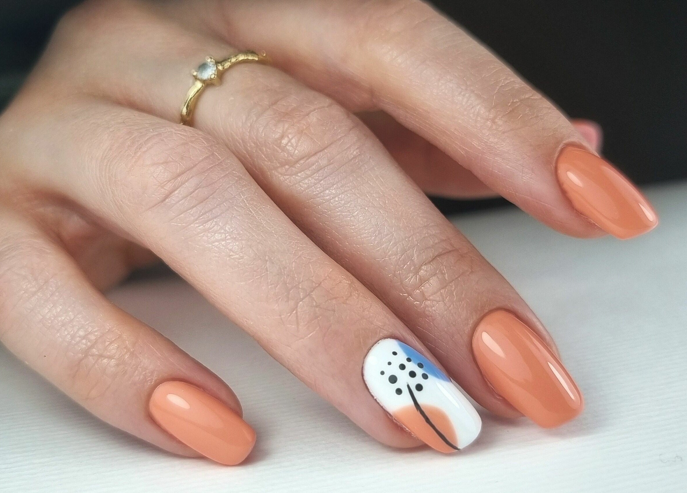 Stylish nail art at Fab Nails Thurles in Thurles, County Tipperary, IE with orange polish and floral design.