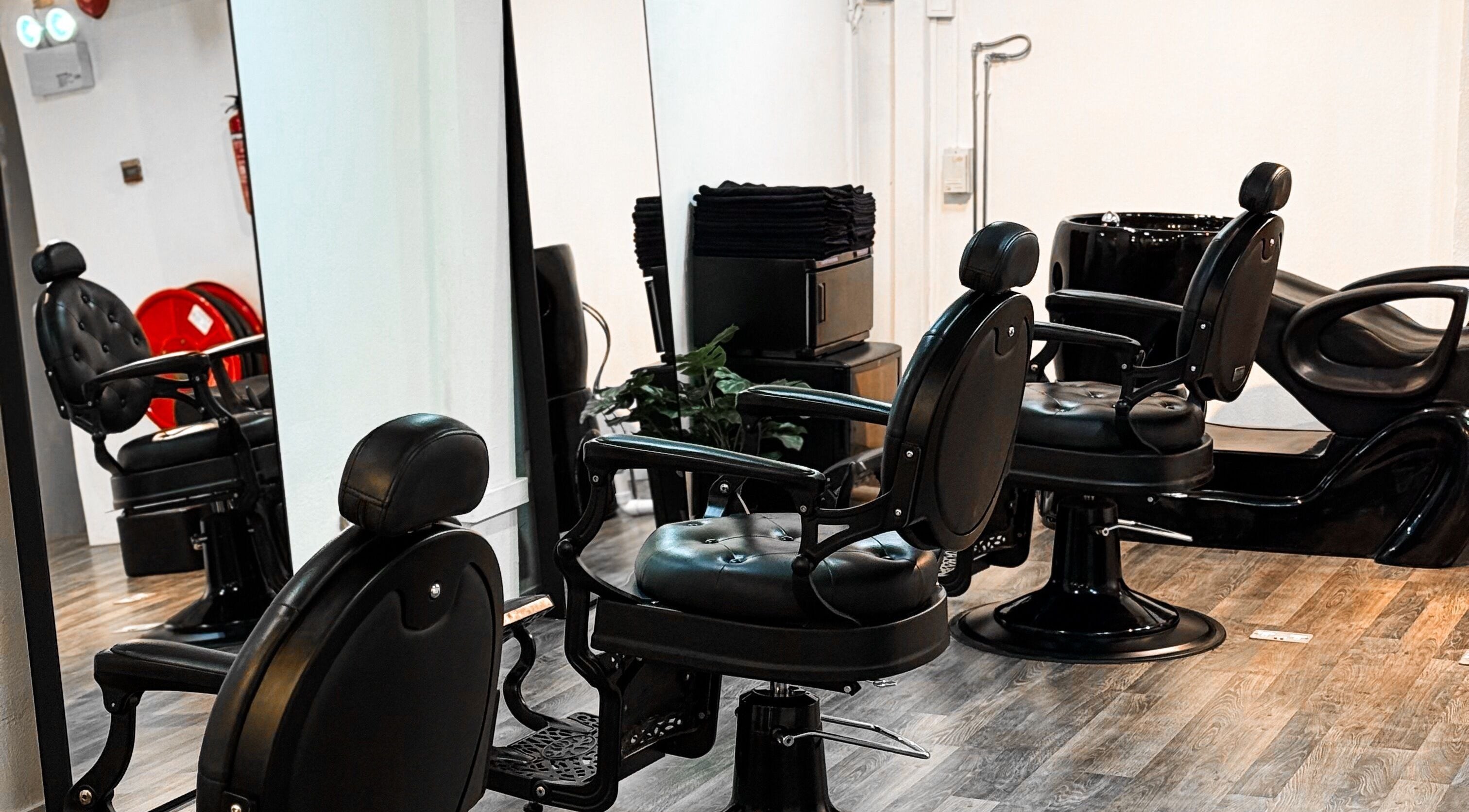 Elegant black salon chairs at Mane Of Man, Singapore, SG, reflecting luxury and comfort.