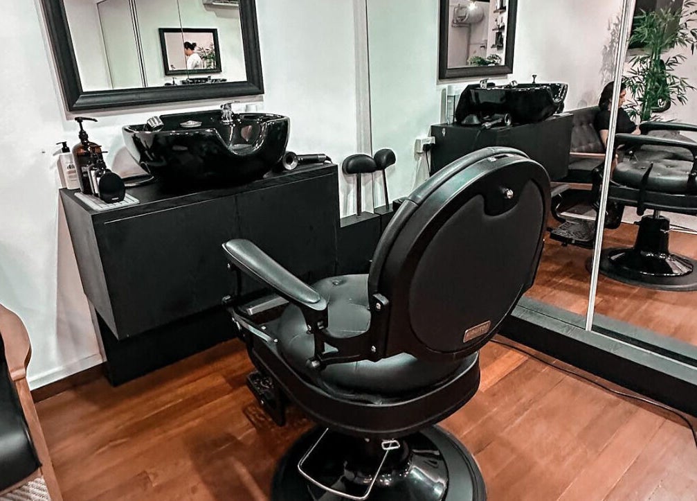 Modern barber chair at Mane Of Man in Singapore, Singapore, SG showcases stylish interior elegance.