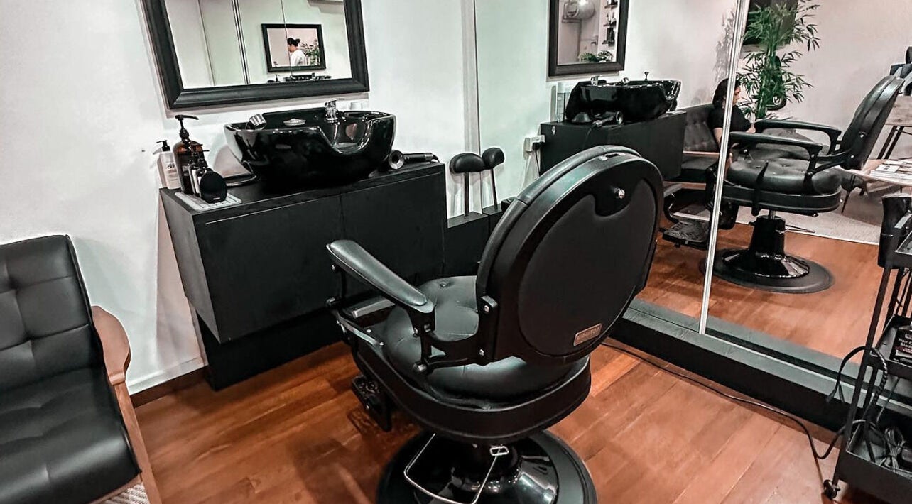 Modern barber chair at Mane Of Man in Singapore, Singapore, SG showcases stylish interior elegance.