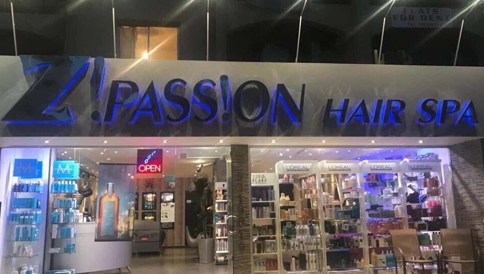 Entrance of Z! Passion Hair Spa in Limassol, CY sparkling at night with beauty products displayed.