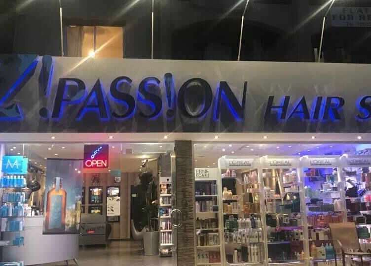 Entrance of Z! Passion Hair Spa in Limassol, CY sparkling at night with beauty products displayed.