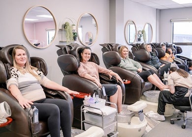 Clients enjoy pedicures at Beautique Nails and Aesthetics & Co Ltd in Taupō, Waikato, NZ, relaxing in massage chairs.