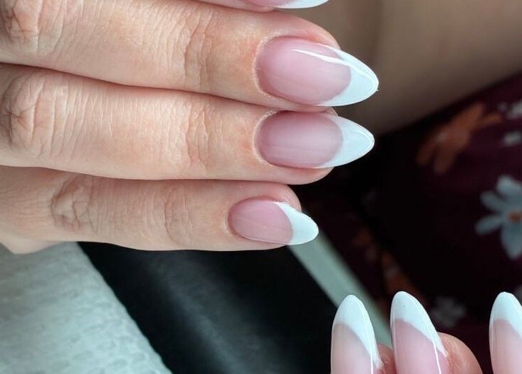 Elegant French manicure at Harmony Nail Studio, Freeport, Freeport, BS showcasing chic nail art.